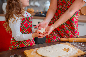 hands of mother and child make cookies