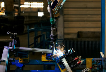 Automated welding robot arm in large factory