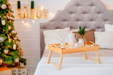 New Year's decor in gold tones, festive tree with gifts, New Year's interior