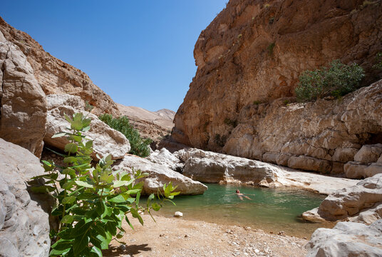 Man swimming in a small lake at Wadi Bani Khalid, Oman