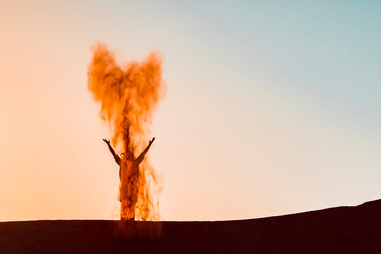 Sultanate Of Oman, Wahiba Sands, Mid adult man is playing with sand in the desert