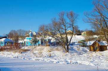 BYKOVO, MOSCOW REGION, RUSSIA - January, 2021: Winter day in the Russian village. The church of the Mother of God Life-Giving Spring on the river Bykovka