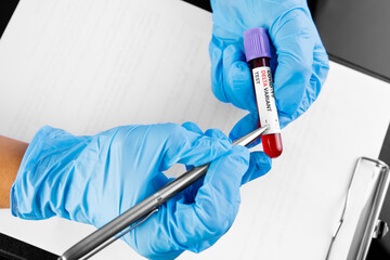 covid 19 delta Variant vaccine and test blood in hand on table background. vaccination against...