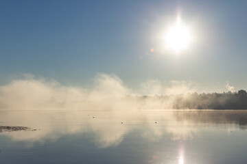 Dawn fog on the river. Fog illuminated by the sun