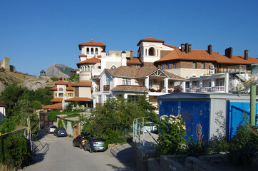 SUDAK, CRIMEA - July, 2020: The street of the city in summer sunny day