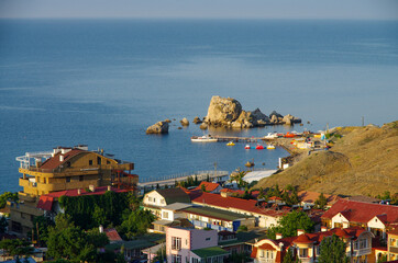 Naklejka premium SUDAK, CRIMEA - July, 2020: Aereal view of coastline in summer morning. Crab island in the Bay of Sudak