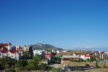 SUDAK, CRIMEA - July, 2020: The street of the city in summer sunny day