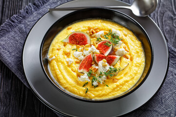 Pumpkin cream soup with thyme with feta and figs