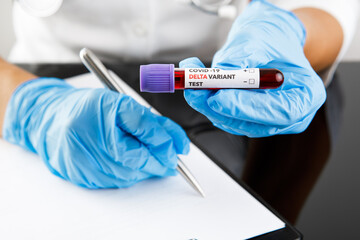covid 19 delta Variant vaccine and test blood in hand on table background. vaccination against...