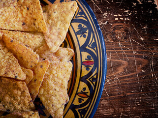 Nacho snack and  rustic appetizer, delicious baked corn tortilla chips chili flavored
