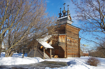 MOSCOW, RUSSIA - February, 2021: Winter day in the Kolomenskoye estate. Church Of St. George The Great Martyr. Three chapters with crosses, wooden architecture of the XVII century