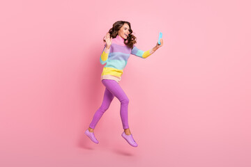 Fototapeta na wymiar Full body profile side photo of young girl walk jump wave hi speak video smartphone isolated over pastel color background