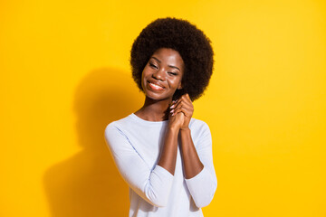 Photo of charming cheerful dark skin lady folded arms palms toothy smile isolated on yellow color background