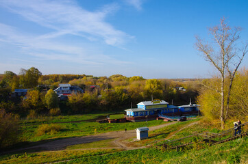 Fototapeta na wymiar Ryazan, Russia - October, 2020: View on the river Trubezh and pier in the town Ryazan