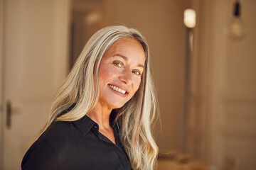 Smiling woman standing at home