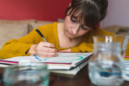 Portrait of woman drawing at home