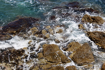 background of beautiful photography of the rocky coast of the clear blue sea