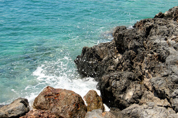 Fototapeta na wymiar background of beautiful photography of the rocky coast of the clear blue sea
