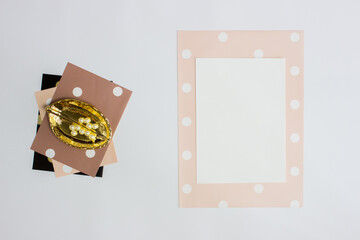 White note with golden leaves over cute paper on white background. 