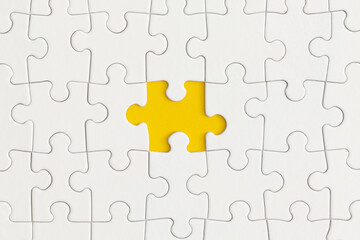 White details of puzzle on yellow background. Business strategy, teamwork.