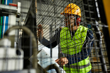 Man operating machine in industrial factory