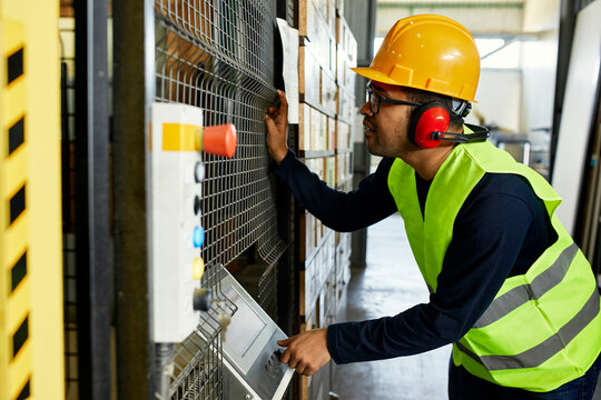 Man operating machine in industrial factory