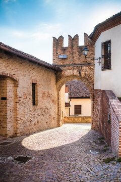 Italy, Piedmont, Old arch over cobblestone street