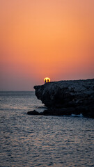 Sunset with 2 people in cliff
