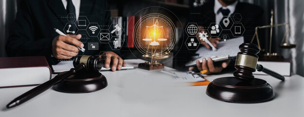 Law and Legal services concept. Lawyer team working with law digital innovation interface icons at table office.