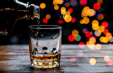 Cheers clinking of friends in party. Whisky In A Glass. Light Bokeh Background.