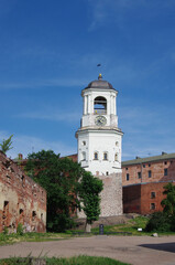 Fototapeta na wymiar Vyborg, Russia - July, 2021: Clock Tower - a tower in Vyborg, the dominant feature of the Old Town, the former cathedral bell tower