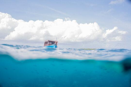 Maldives, split shot of boat on water