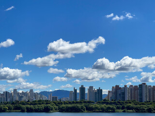 Fototapeta premium city skyline with beautiful white clouds in the blue sky 