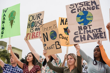 Young group of demonstrators on road from different culture and race fight for climate change -...