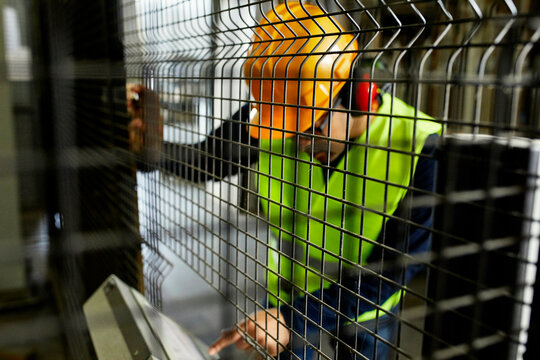 Man operating machine in industrial factory