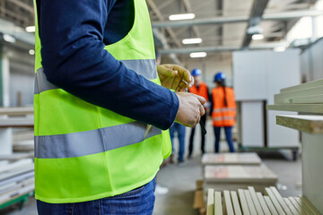 Close-up of worker wearing reflective vest in factory