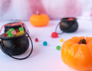 little cauldrons and halloween pumpkins crammed with treats on bloodstained white tablecloth