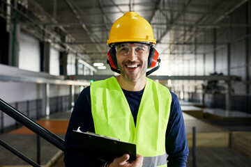 Portrait of happy worker in factory warehouse