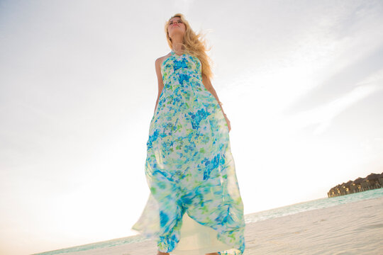 Beatiful blond woman standing on the beach