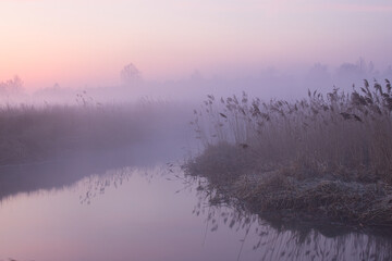 morning fog over the river red dawn