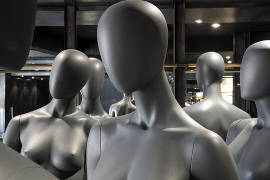 Faceless grey female display dummies, partial view