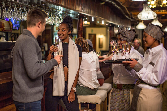 Couple having a glass of champagne in a bar