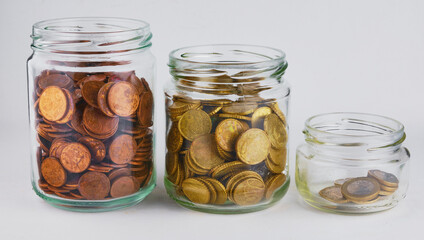 Saving money concept of collecting coins in glass bottle Isolated on white background.