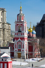 Moscow, Russia - March, 2021:  Bell tower and Church of St. George on Pskov hill in the landscape...