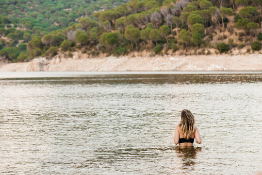 Young woman bathing in lake