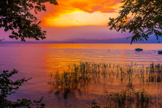 Italy, Province of Verona, Lazise, Lake Garda at moody sunset