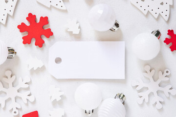 Blank gift tag with Christmas decorations around top view, Mockup