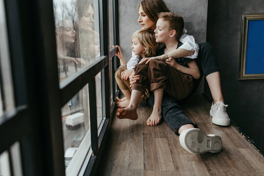 Full length of family looking through window at home