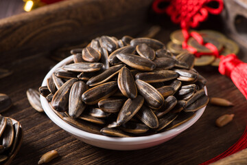 roasted sunflower seeds in small plate on wood background