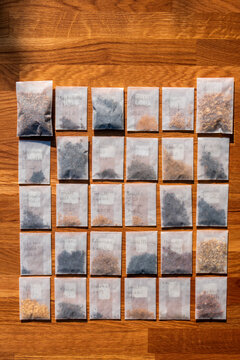 Plant seeds in small packages on wooden table at home